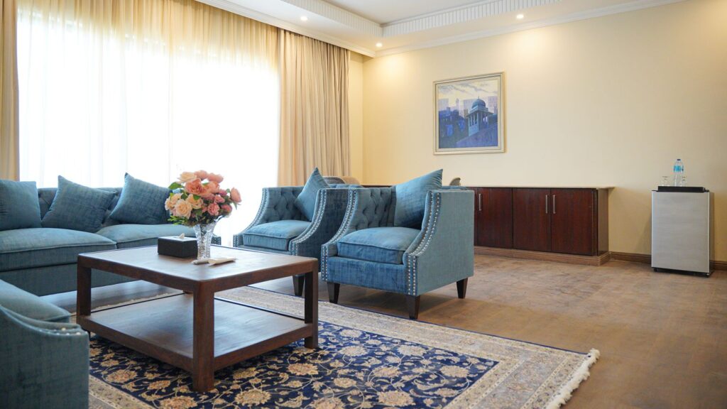 Sitting area of a suite with blue armchairs