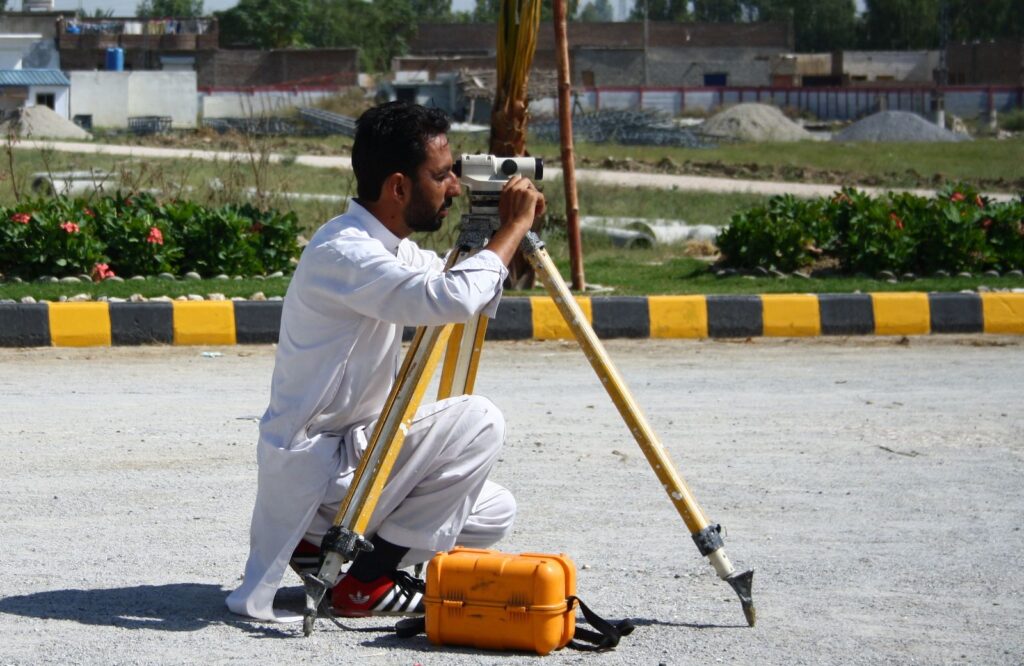 A Toru Enterprises surveyor at work on site